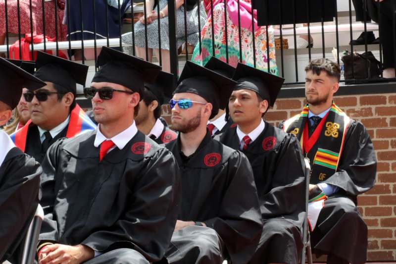 a group of people in graduation gowns and caps