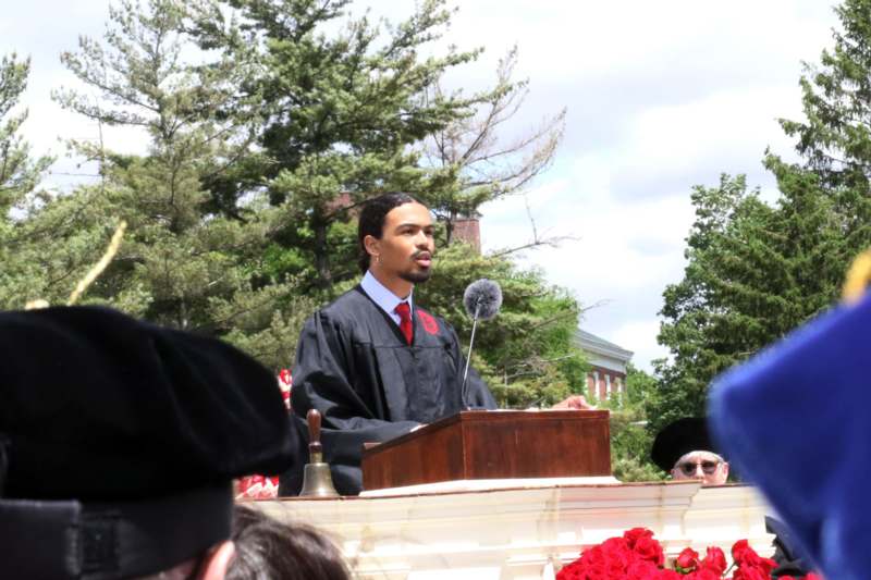 a man in a robe standing at a podium
