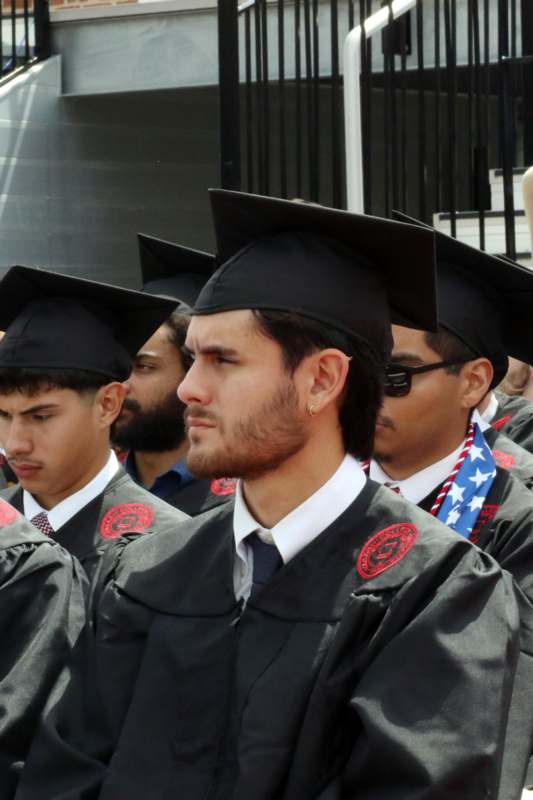 a group of men in graduation gowns