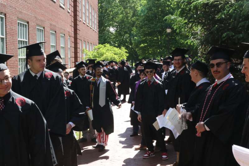 a group of people in graduation gowns and caps