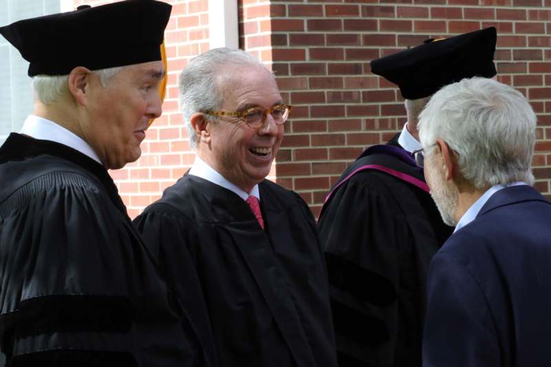 a group of men in graduation gowns