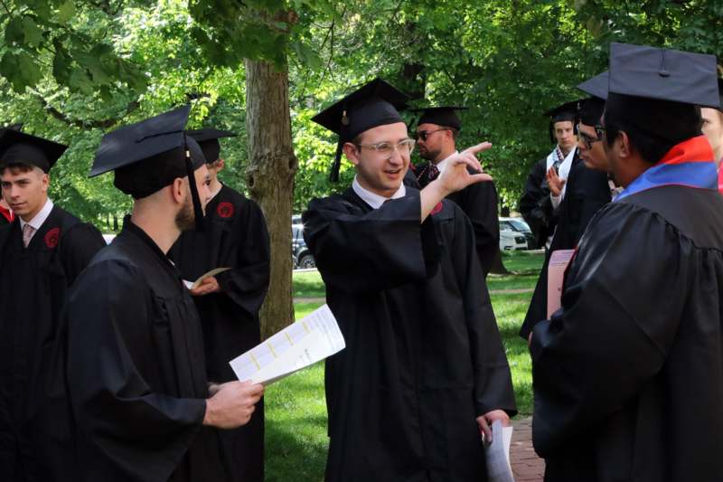 a group of people in graduation gowns and caps