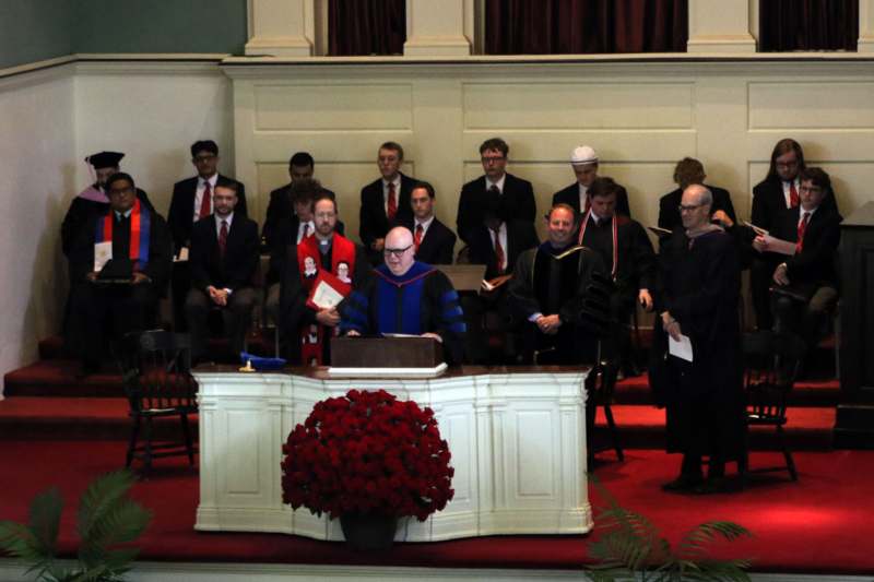 a group of people standing around a podium