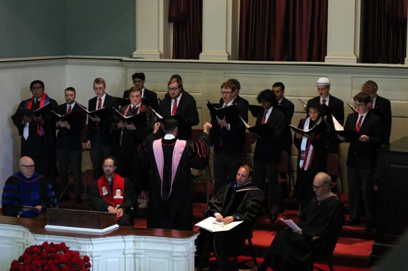 a group of people in robes singing
