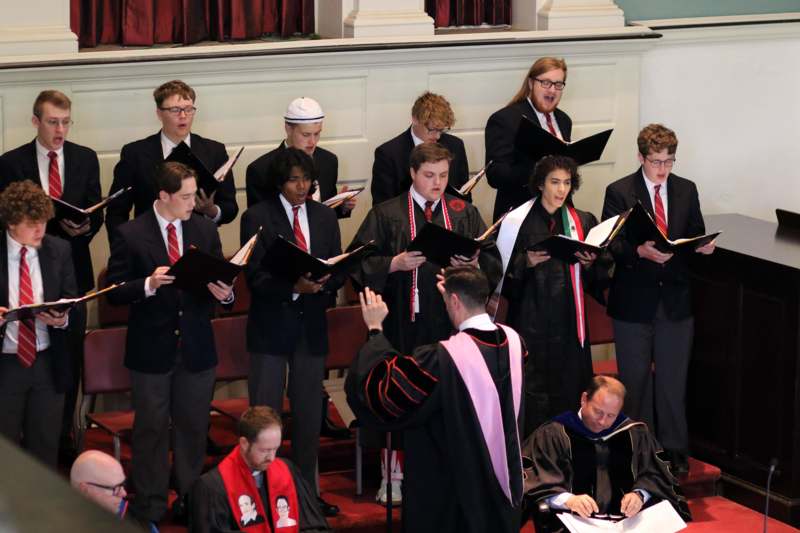 a group of people singing in a choir
