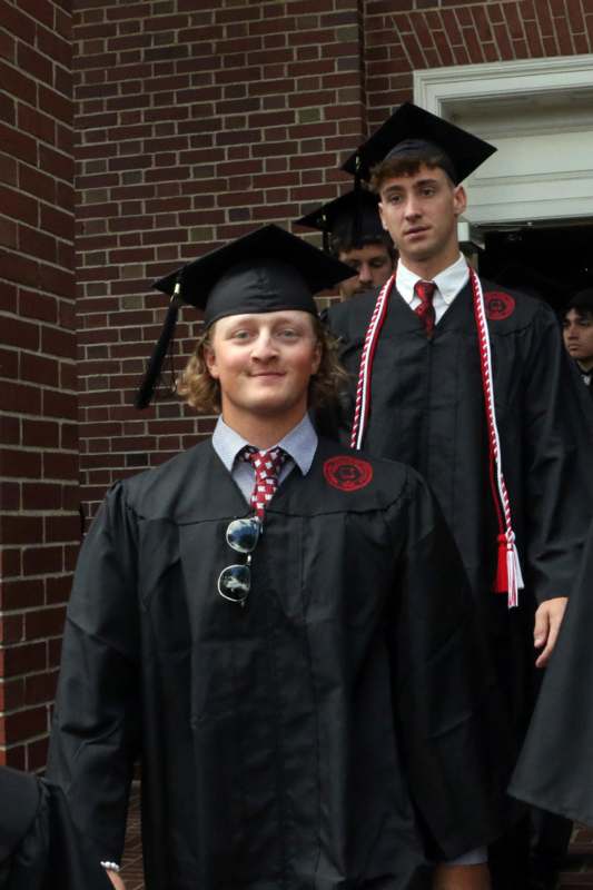 a group of men in graduation gowns