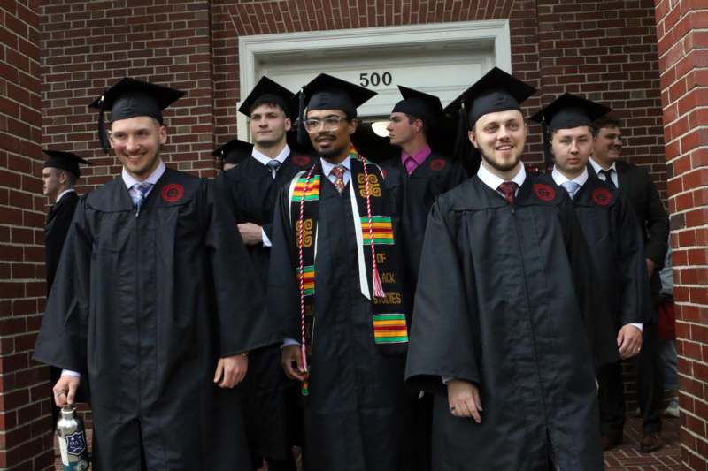 a group of people in graduation gowns and caps