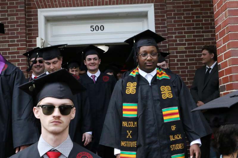 a group of people in graduation gowns and caps