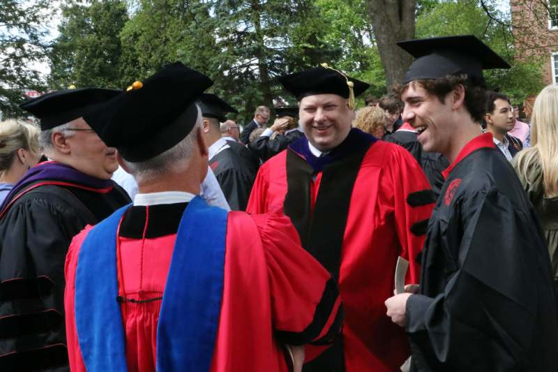 a group of people wearing graduation gowns and caps
