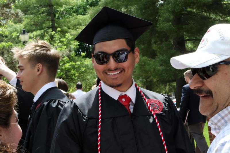 a man in a graduation gown and cap