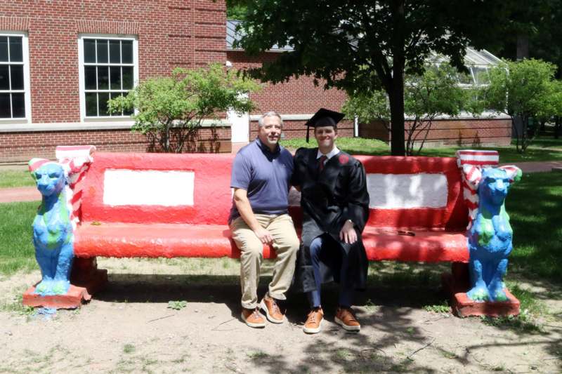 a man and a man sitting on a bench