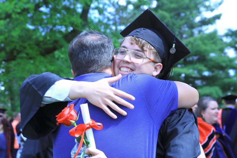 a man hugging a boy