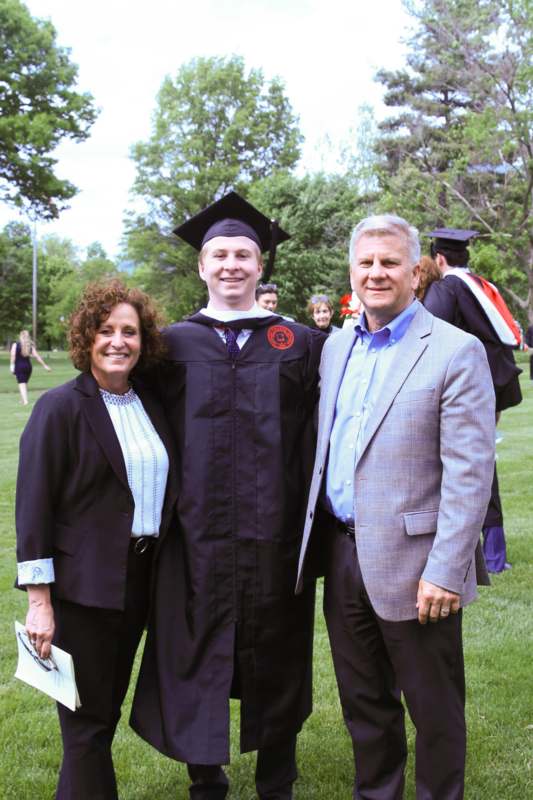 a man and woman standing in a graduation gown