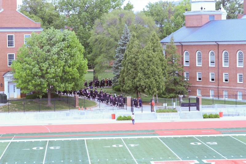 a group of people walking on a football field