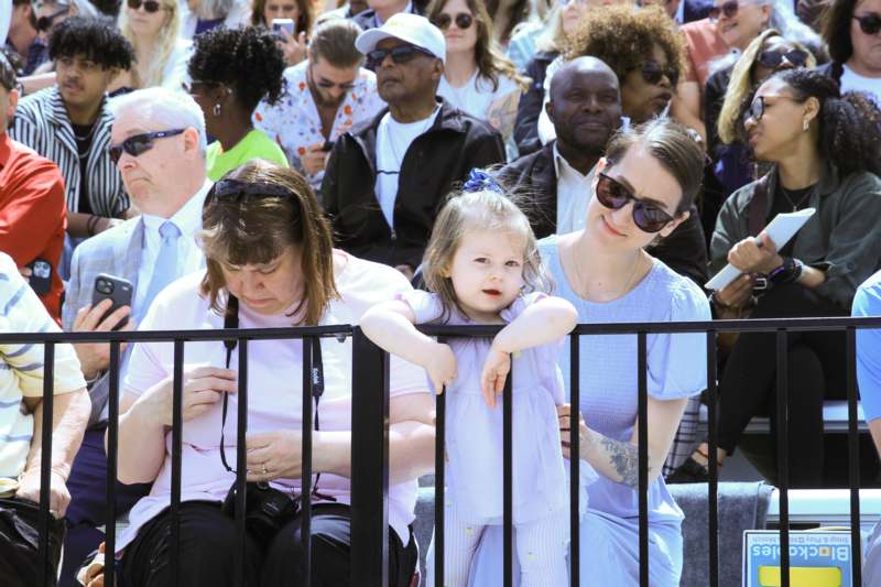 a group of people sitting on a railing