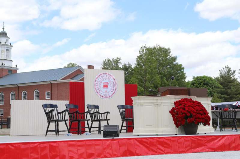 a stage with chairs and a podium