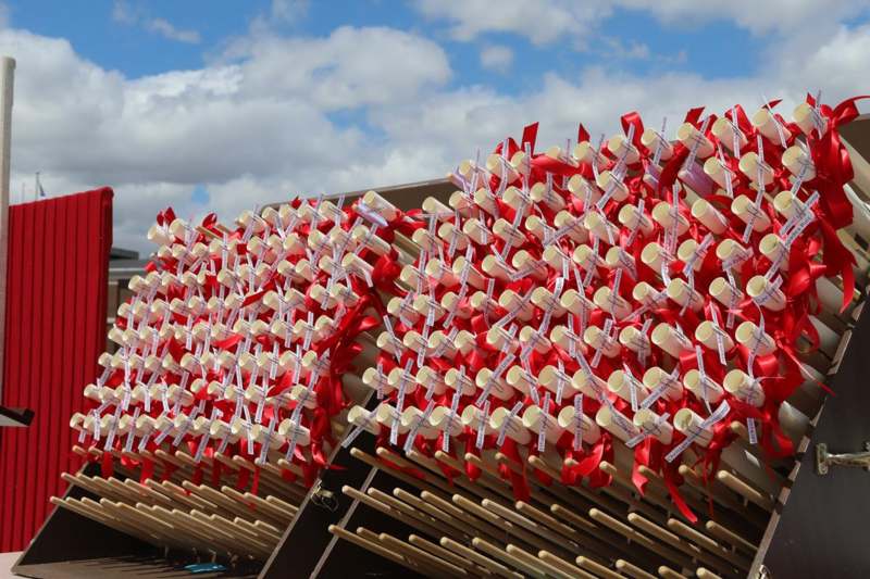 a group of candles with red ribbons