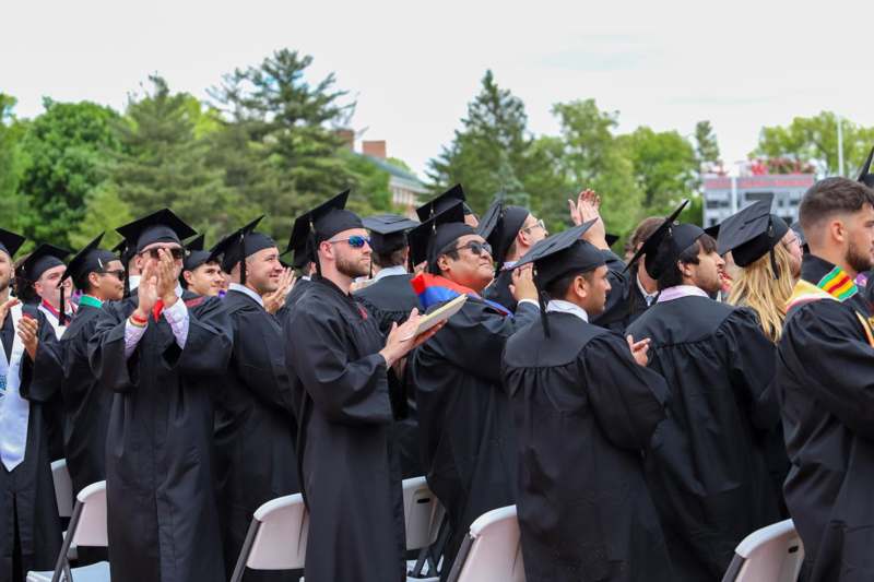 a group of people in graduation gowns and caps