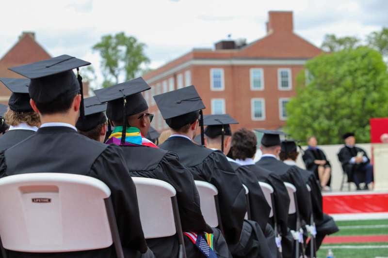 a group of people in graduation gowns and caps