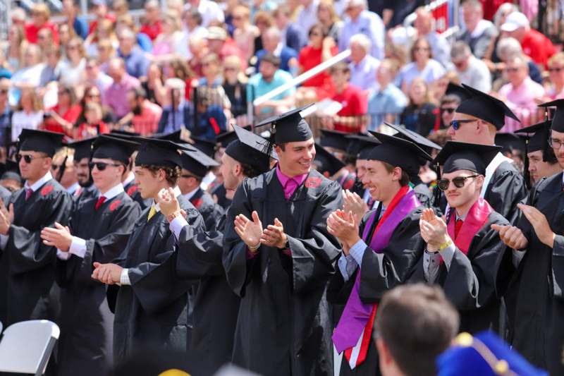 a group of people in graduation gowns and caps
