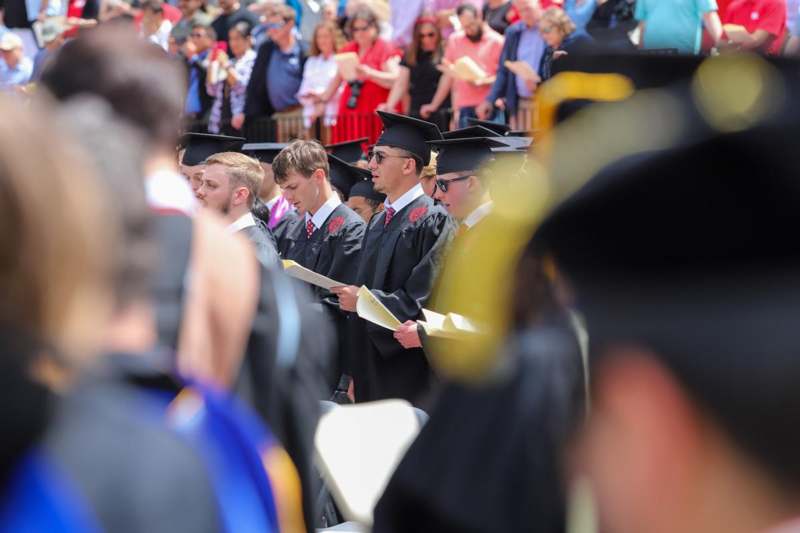 a group of people in graduation gowns and caps