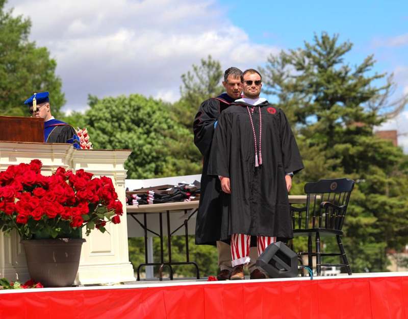 a group of men wearing graduation gowns