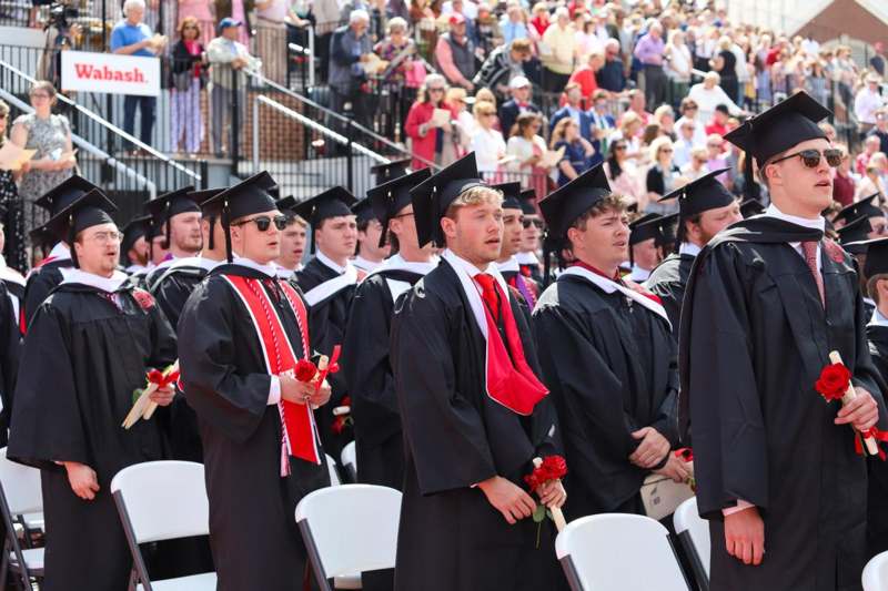 a group of people in graduation gowns and caps