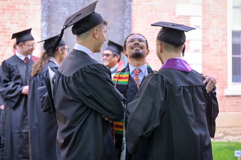 a group of people in graduation gowns and caps