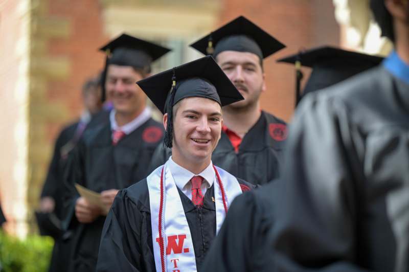 a group of people wearing graduation gowns and caps