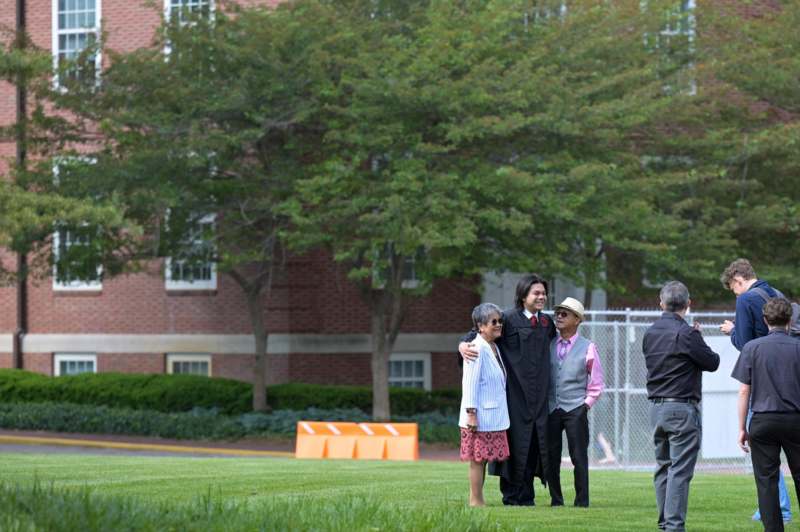 a group of people standing on a grass field