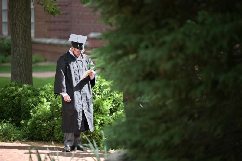 a man in a graduation gown and cap