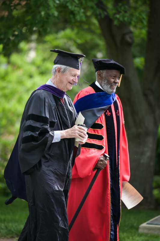 a man in a graduation gown and cap