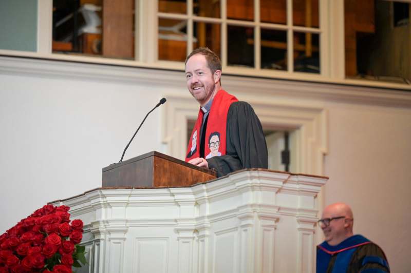 a man in a robe at a podium
