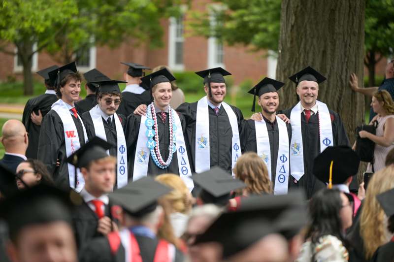 a group of people in graduation gowns and caps