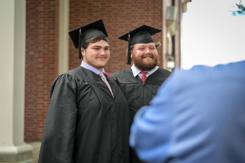 a group of men in graduation gowns