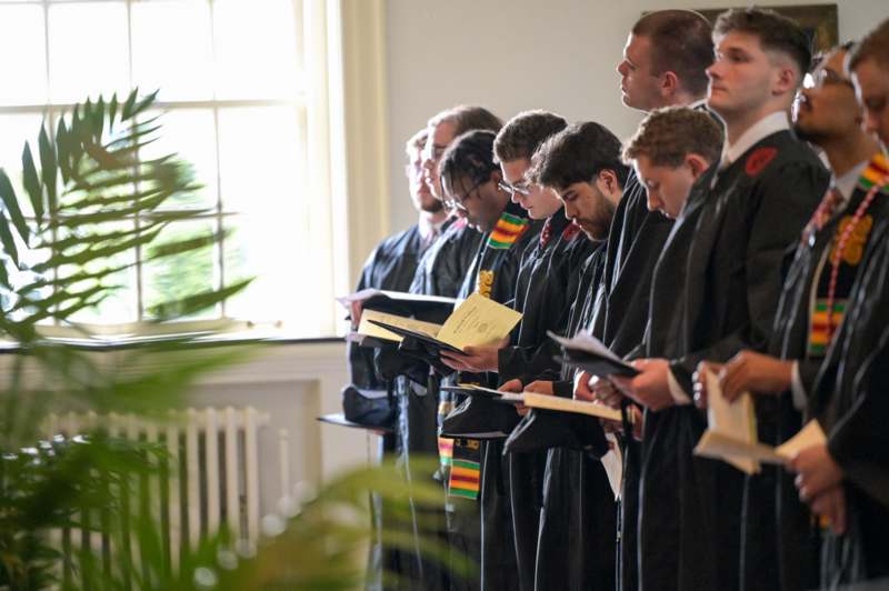 a group of people in black robes