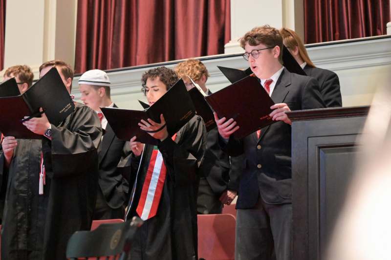 a group of people singing in a choir