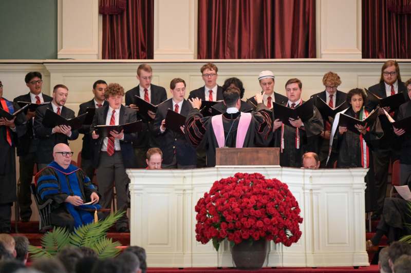 a group of people singing in a choir