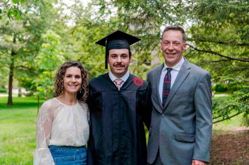a man in a cap and gown with a woman in a suit and tie