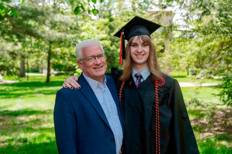 a man and woman in graduation gowns