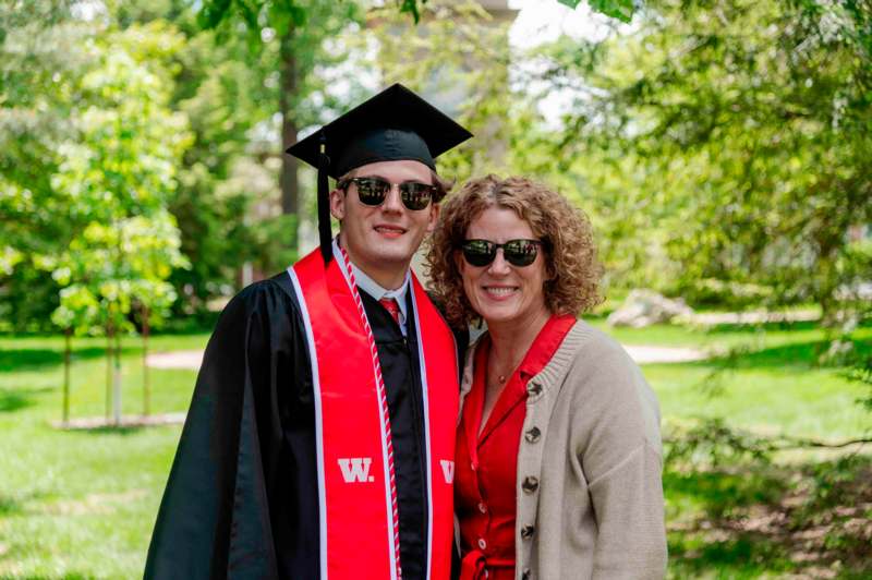 a man and woman in graduation gowns and cap and gown