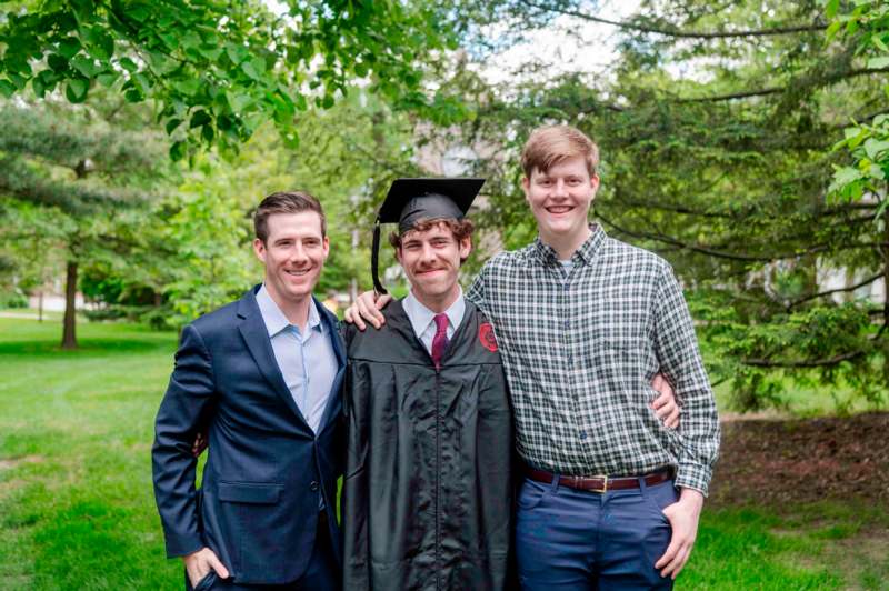 a group of men standing together and smiling