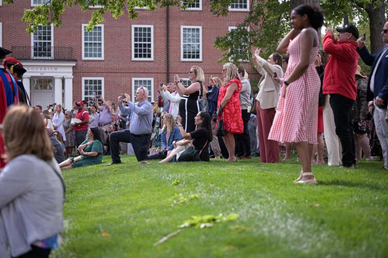 a group of people standing on grass
