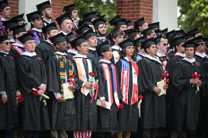 a group of people in graduation gowns and caps
