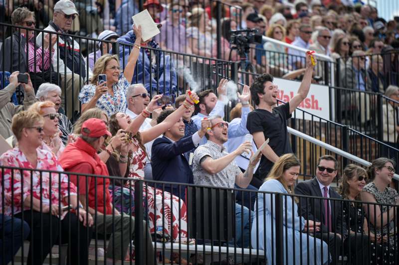 a group of people sitting in bleachers