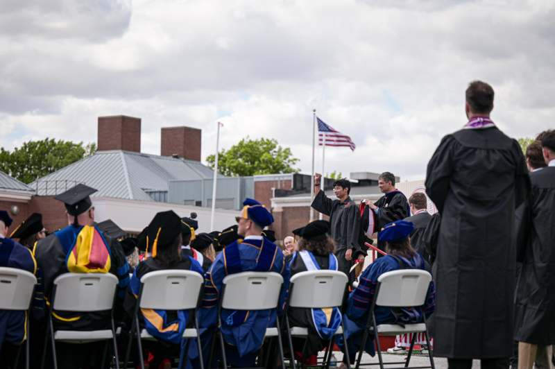 a group of people in graduation gowns and caps