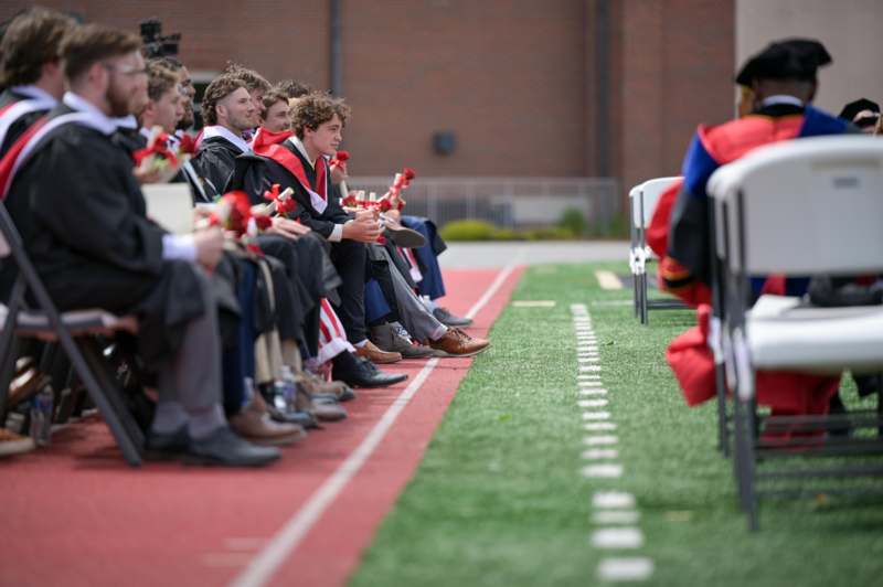 a group of people sitting on a track