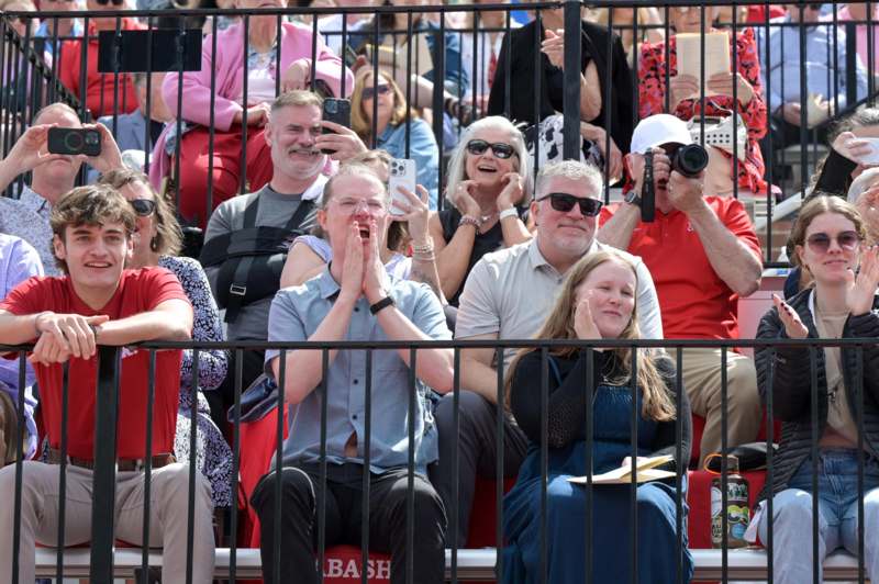 a group of people sitting in bleachers