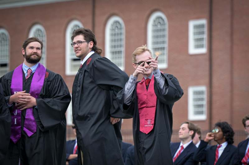 a group of men in graduation gowns