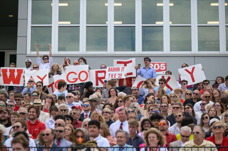 a large crowd of people holding signs